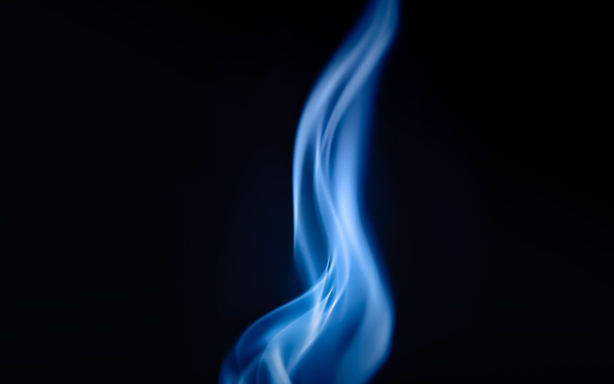 Blue gas flame on a cooktop burner in a Victorian home