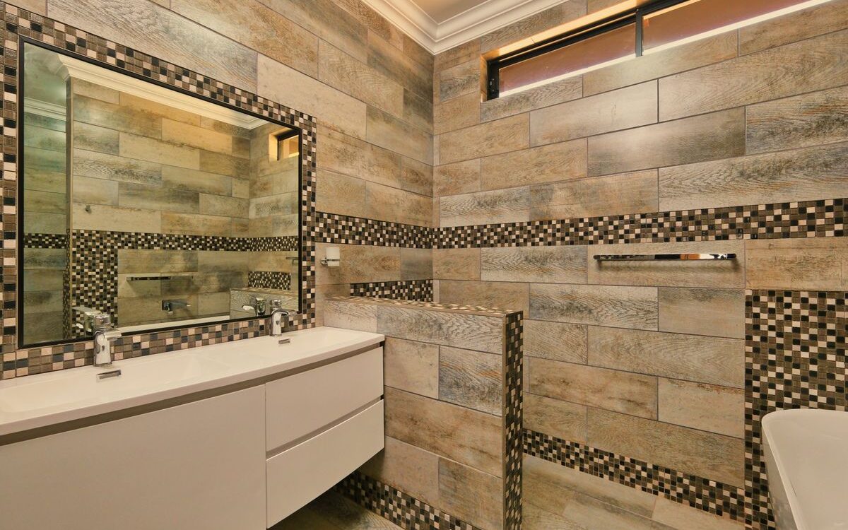 Renovated bathroom with new plumbing fixtures and tiling