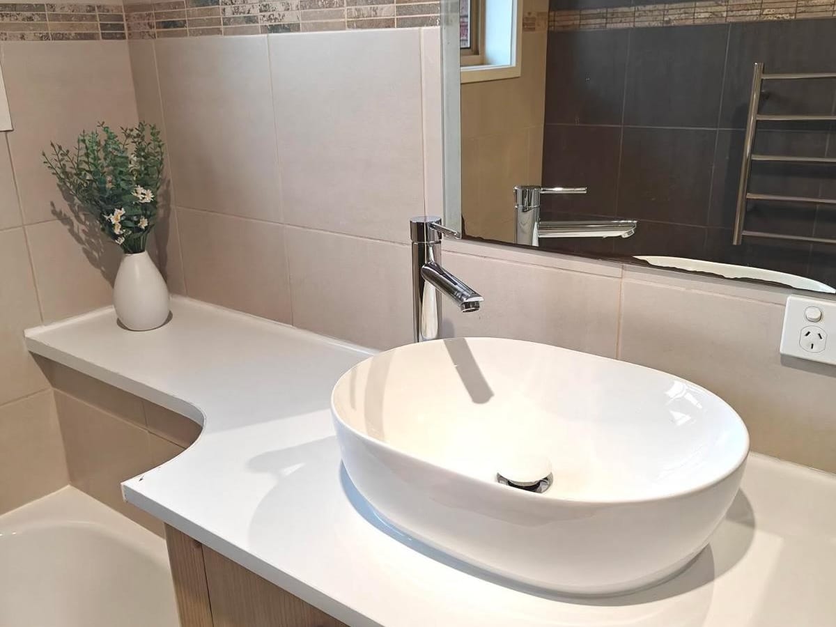 Above counter basin with a tall mixer tap
