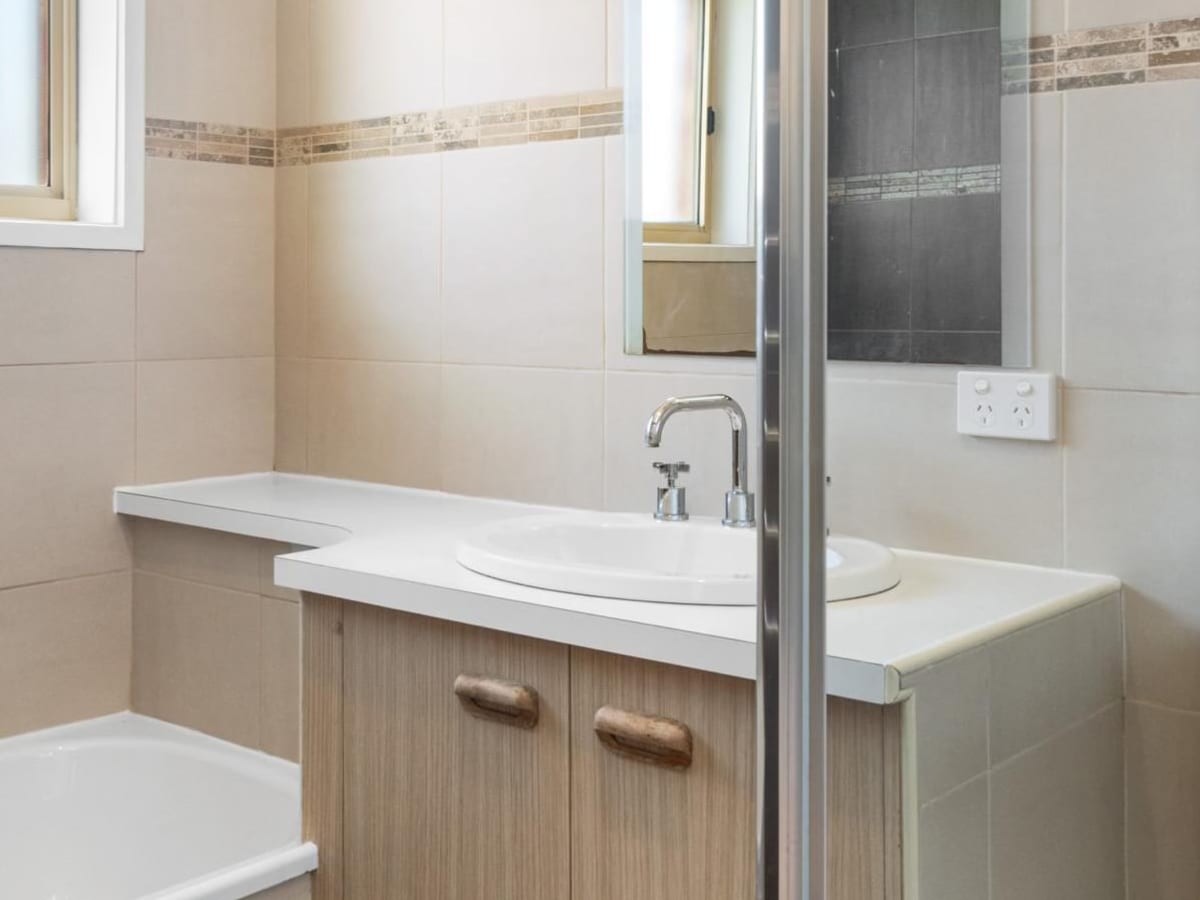 Bathroom vanity, bath and shower screen after renovation