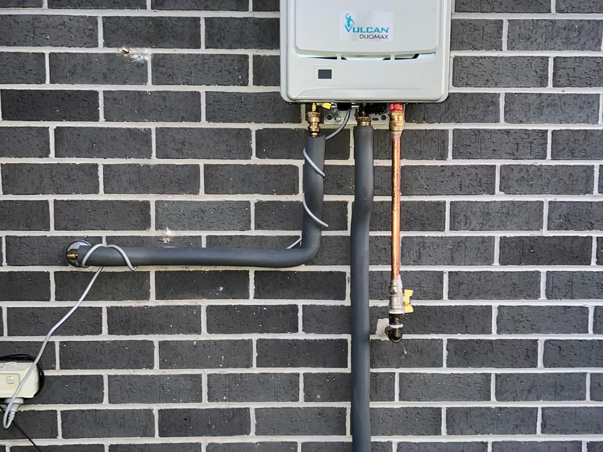 Pipework under a continuous flow hot water unit