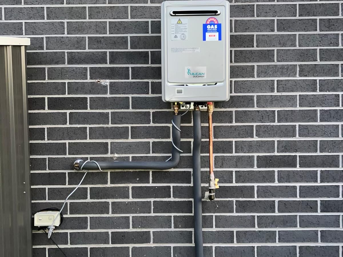 Continuous flow hot water unit on a brick wall