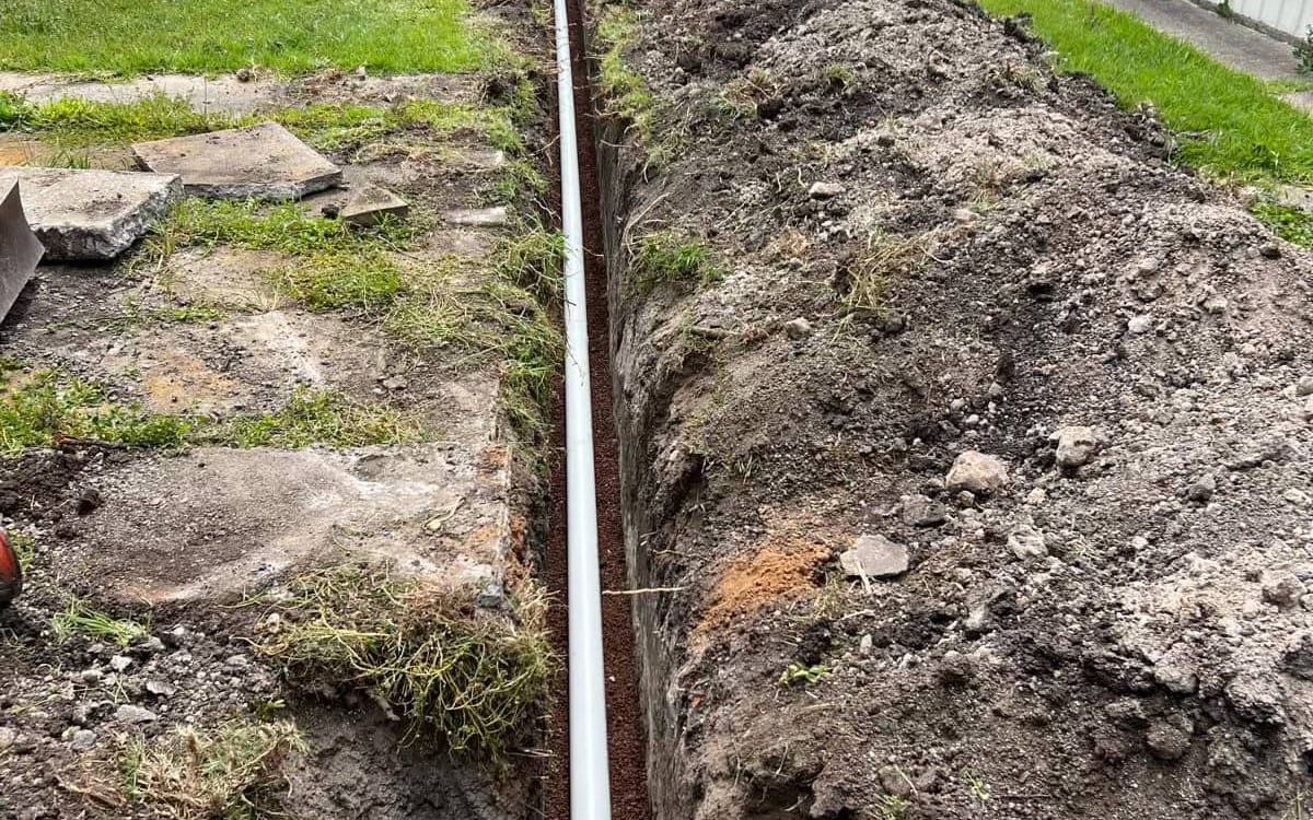 New sewer pipe laid in a trench to a house