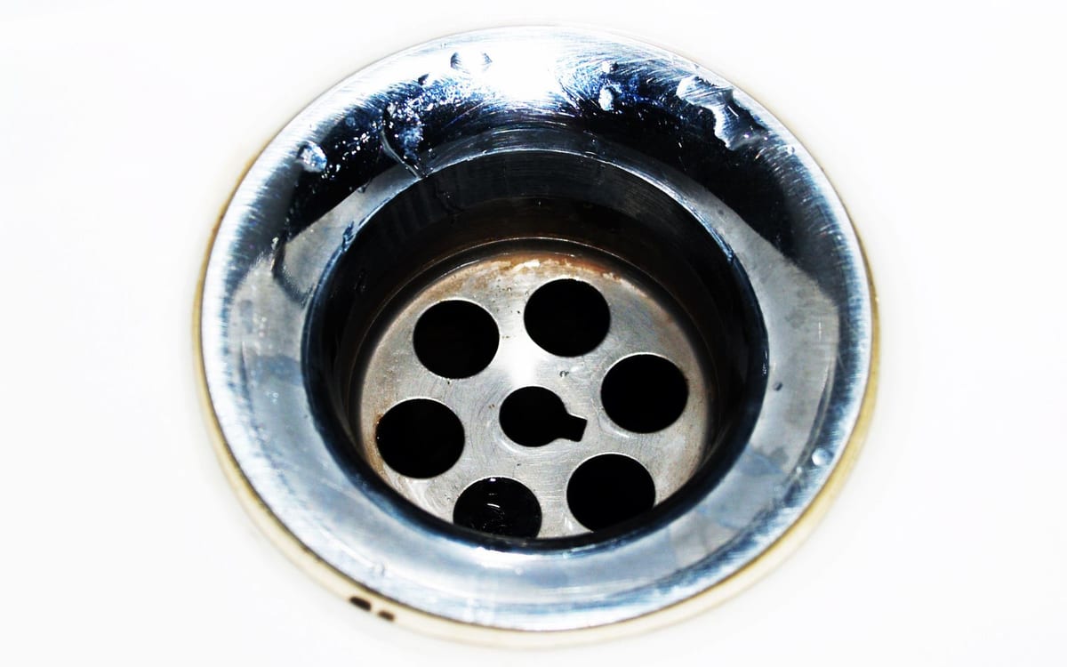 Chrome sink drain with water droplets