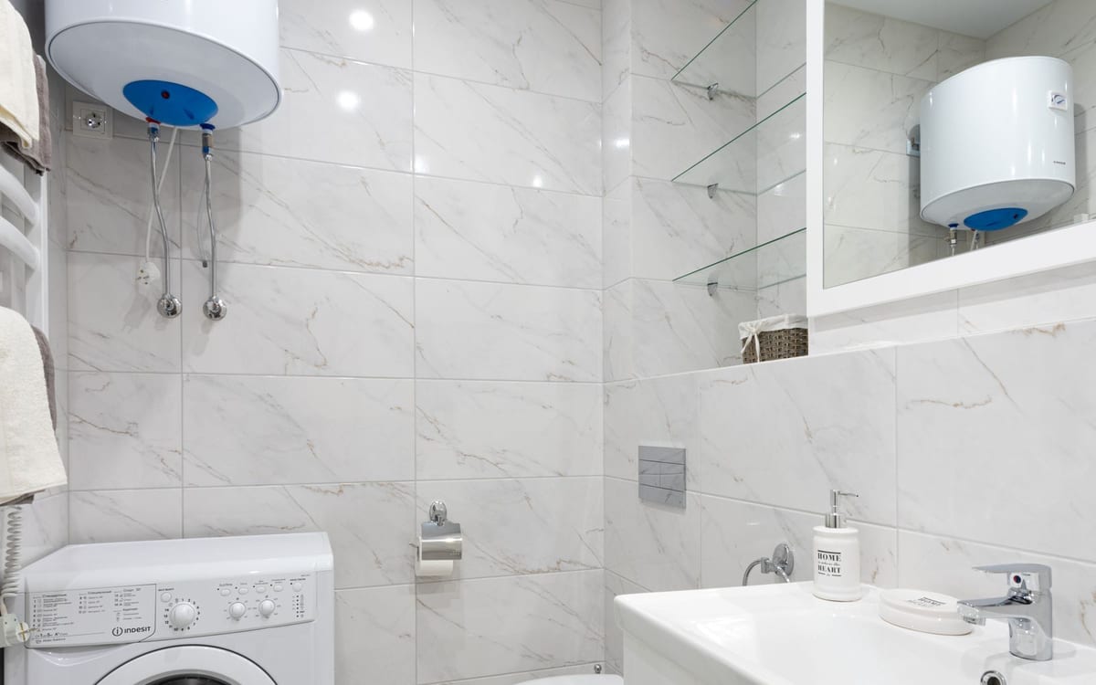 Wall mounted electric hot water unit in a bathroom