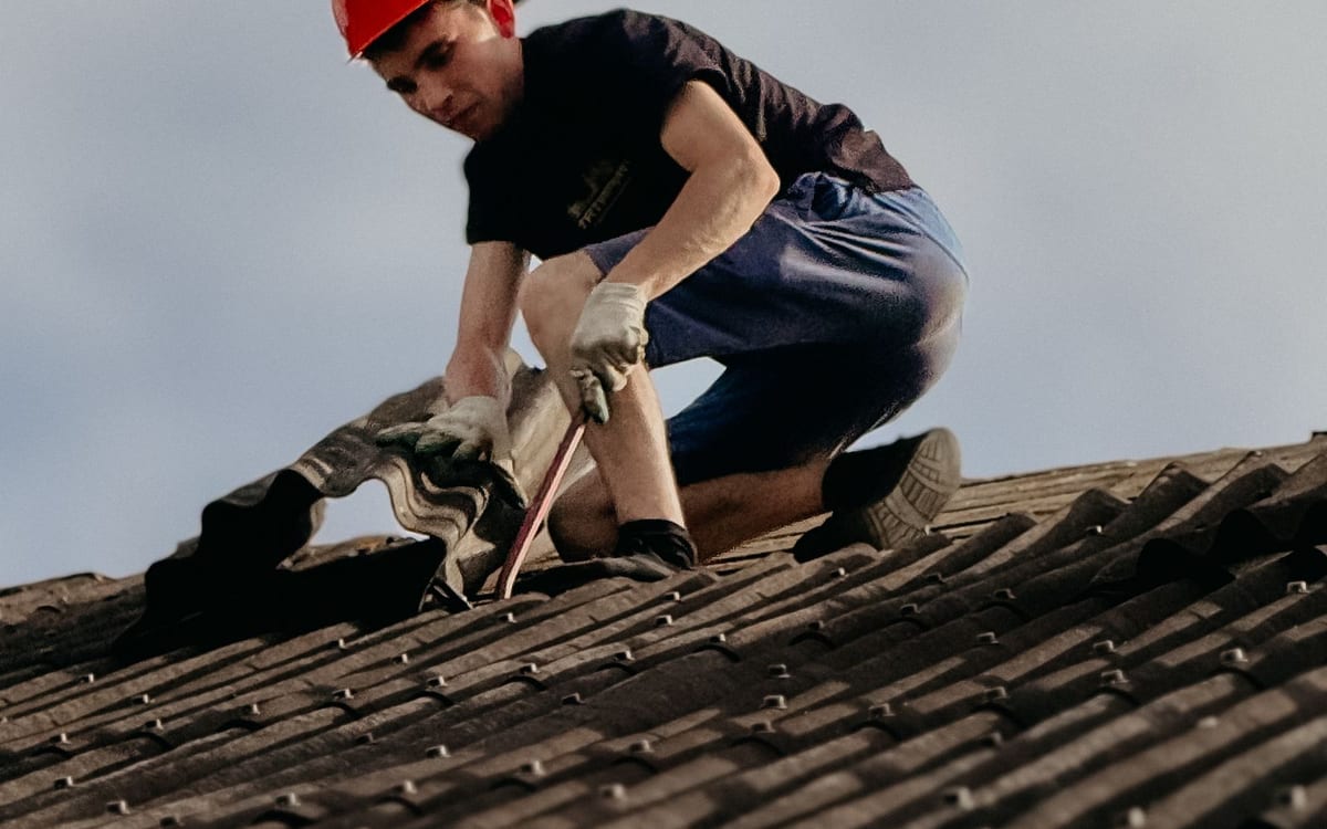 Roof plumber repairing a tiled roof
