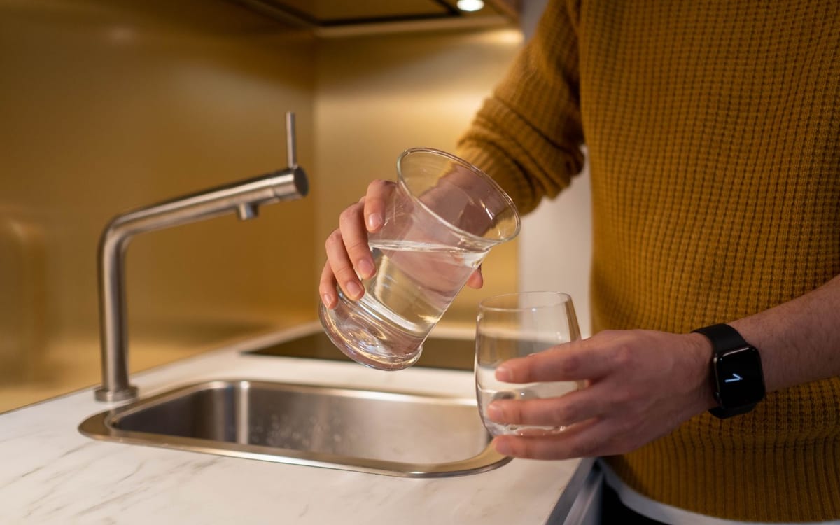 Filling a glass of filtered water at the kitchen tap